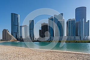 Beautiful modern city surrounded by water | Al Reem island buildings such as Sun and Sky towers in Abu Dhabi city, United Arab Emi