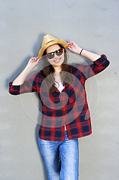 Beautiful modern girl near the wall. Youth style. Fashion shot.