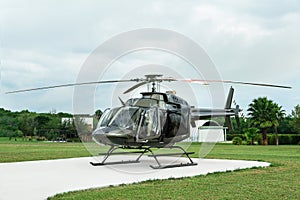 Beautiful modern helicopter on helipad in field