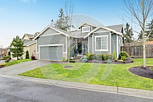 Beautiful modern home with grass and driveway.