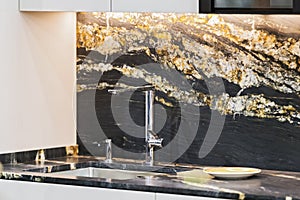 Beautiful modern kitchen design, kitchen faucet, black and gold stone marble countertop kitchen