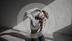 Beautiful, modern teenage girl dancer dancing contemp in the studio slow motion