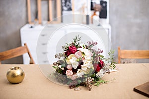 Beautiful modern wedding bouquet on the table. Against the gray wall