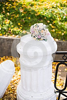 Beautiful modern wedding bouquet on white colomn