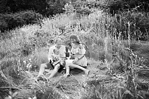 Beautiful mom and dad with little daughter enjoy picnic in summer