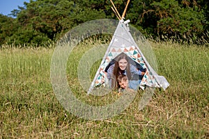 Beautiful mom with her son on a picnic rest in nature