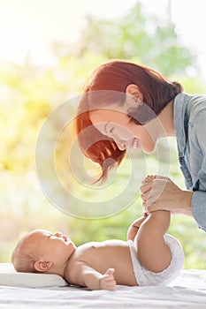 Beautiful mom playing with her baby