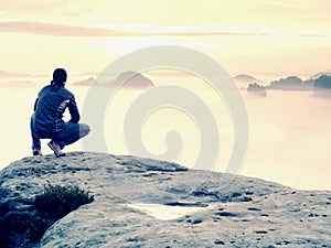 Beautiful moment the miracle of nature. Colorful mist in valley. Man hike. Person silhouette stand