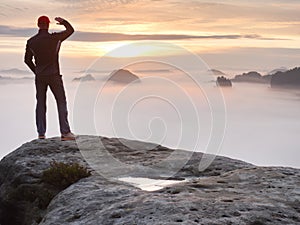 Beautiful moment the miracle of nature. Colorful mist in valley. Man hike. Person silhouette stand