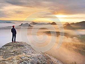 Beautiful moment the miracle of nature. Colorful mist in valley. Man hike. Person silhouette stand