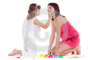 beautiful mommy and her kid paintig a picture for kindergardern. hobby, education, development , child developing photo