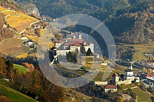 The Beautiful Monastery of Sabiona near Chiusa & x28;Klausen& x29; surrounded by its yellow vineyards. Valle Isarco, Bolzano.