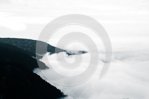 A beautiful monochromatic mountain view with rising clouds