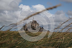 Beautiful Mont Saint Michel cathedral on the island, Normandy, Northern France, Europe. with livestock of sheeps. View at the Mont