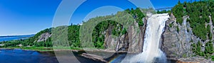 Beautiful Montmorency Falls with rainbow and blue sky. View of Canadian fall located near Quebec City, Canada in North America