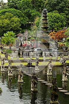 Beautiful monument on indonesian culture and history - Tirta Gangga park with lush green tropical trees, pond, fountain, foothpath