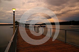 Beautiful moody evening: Lantern on a landing stage - idyllic lake in canada