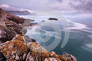 A beautiful moody golden seascape taken on a stormy cloudy evening after sunset