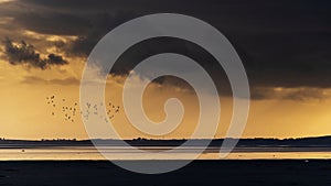 Beautiful moody storm skies over ocean landscape with distant heavy rainfall