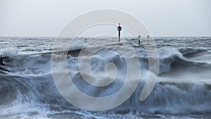 Beautiful dramatic stormy landscape image of waves crashing onto