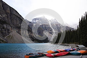 Beautiful Moraine Lake in Alberta, Canada, with colorful kayaks on the shore