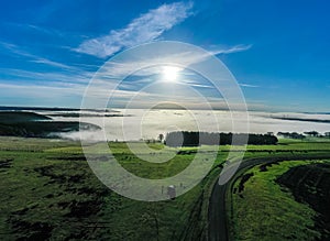 Beautiful morning of drone footage overlooking welsh sceneray with fog sheet covering the lower valleys in south wales photo