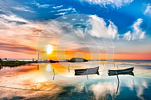 Beautiful morning landscape with boats on the lake anchored to the pier and wood bridges at sunrise