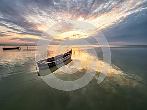 Beautiful morning landscape with boats on the lake at the sunrise