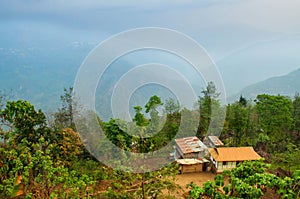 Beautiful morning in mountains of Himalayas, Hee Barmiok village of Sikkim, India. Wooden houses in the middle of scenic view of