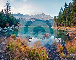 Beautiful morning scene of Eibsee lake with Zugspitze mountain range on background. Colorful autumn view of Bavarian Alps, Germany