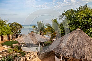 Beautiful morning view on the Indian ocean and the beach from balcony over the hut-tops