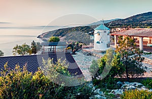 Beautiful morning view of Potamitis Windmill. Bright spring scene of Zakynthos island, Korithi location, Ionian Sea, Greece,