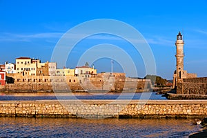 Beautiful morning view of Venetian Lighthouse, Firka castle walls and piers of Old Venetian harbour of Chania, Crete
