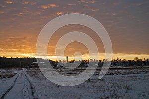 Beautiful morning and winter bright sunrise in January. Suburb and field covered snow