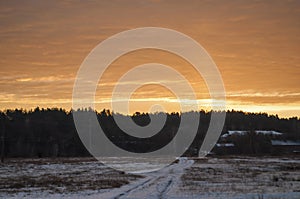 Beautiful morning and winter bright sunrise in January. Suburb and field covered snow