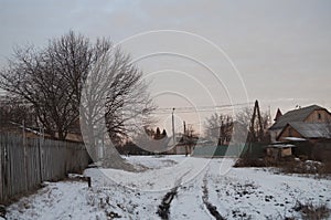 Beautiful morning and winter bright sunrise in January. Suburb and field covered snow