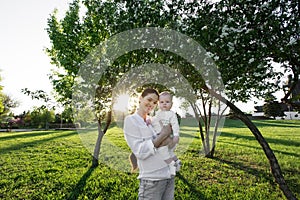 Beautiful Mother And Baby outdoors. Nature. Beauty Mum and her Child playing in Park.