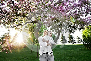 Beautiful Mother And Baby outdoors. Nature. Beauty Mum and her Child playing in Park.