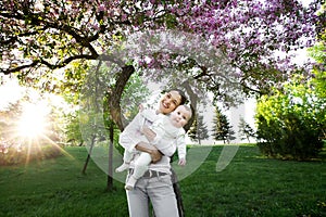 Beautiful Mother And Baby outdoors. Nature. Beauty Mum and her Child playing in Park.