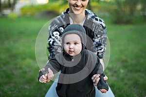 Beautiful Mother And Baby outdoors. Nature. Beauty Mum and her Child playing in Park.