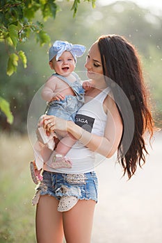 Beautiful mother and baby outdoors in summer Park