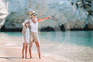 Beautiful mother and daughter at the beach enjoying summer vacation.