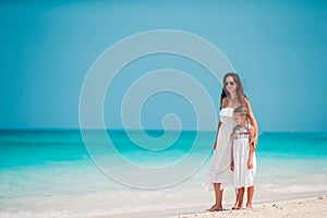 Beautiful mother and daughter at the beach enjoying summer vacation.