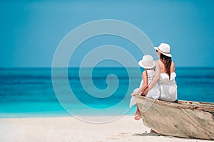 Beautiful mother and daughter at the beach enjoying summer vacation.