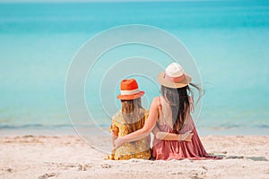 Beautiful mother and daughter at the beach enjoying summer vacation.