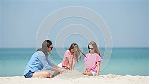 Beautiful mother and daughter at beach enjoying summer vacation.