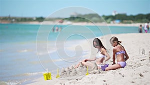 Beautiful mother and daughter on the beach enjoying summer vacation