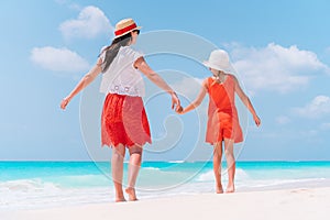 Beautiful mother and daughter at the beach enjoying summer vacation.