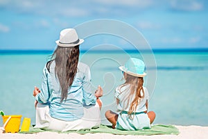 Beautiful mother and daughter at Caribbean beach enjoying summer vacation.