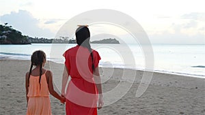 Beautiful mother and daughter on Caribbean beach. Family beach vacation